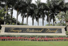 2026 Cadillac Championship payout, purse: How much does each player get? Trump National Doral sign set in a landscaped garden with palm trees and red flowers in front